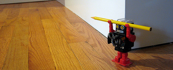 toy robot lifting pencil